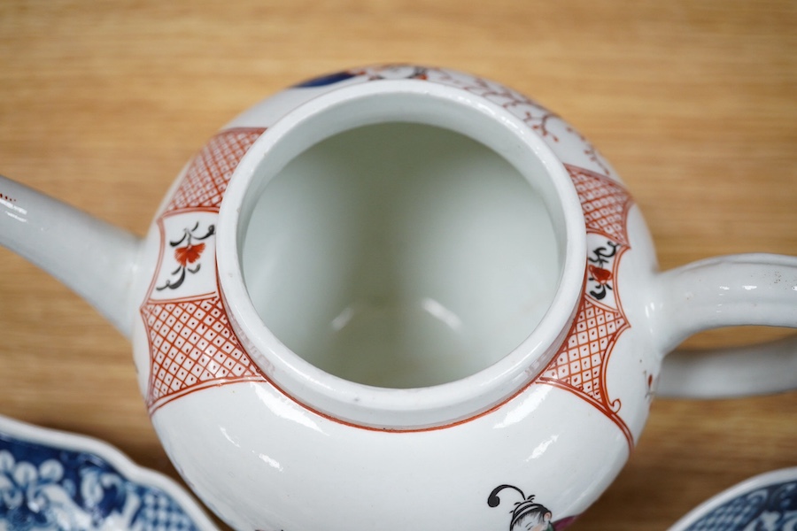 An 18th century Worcester Chinese style teapot, and a similar pine cone pattern strainer and plate (3). Condition - teapot cracked and chipped, others good